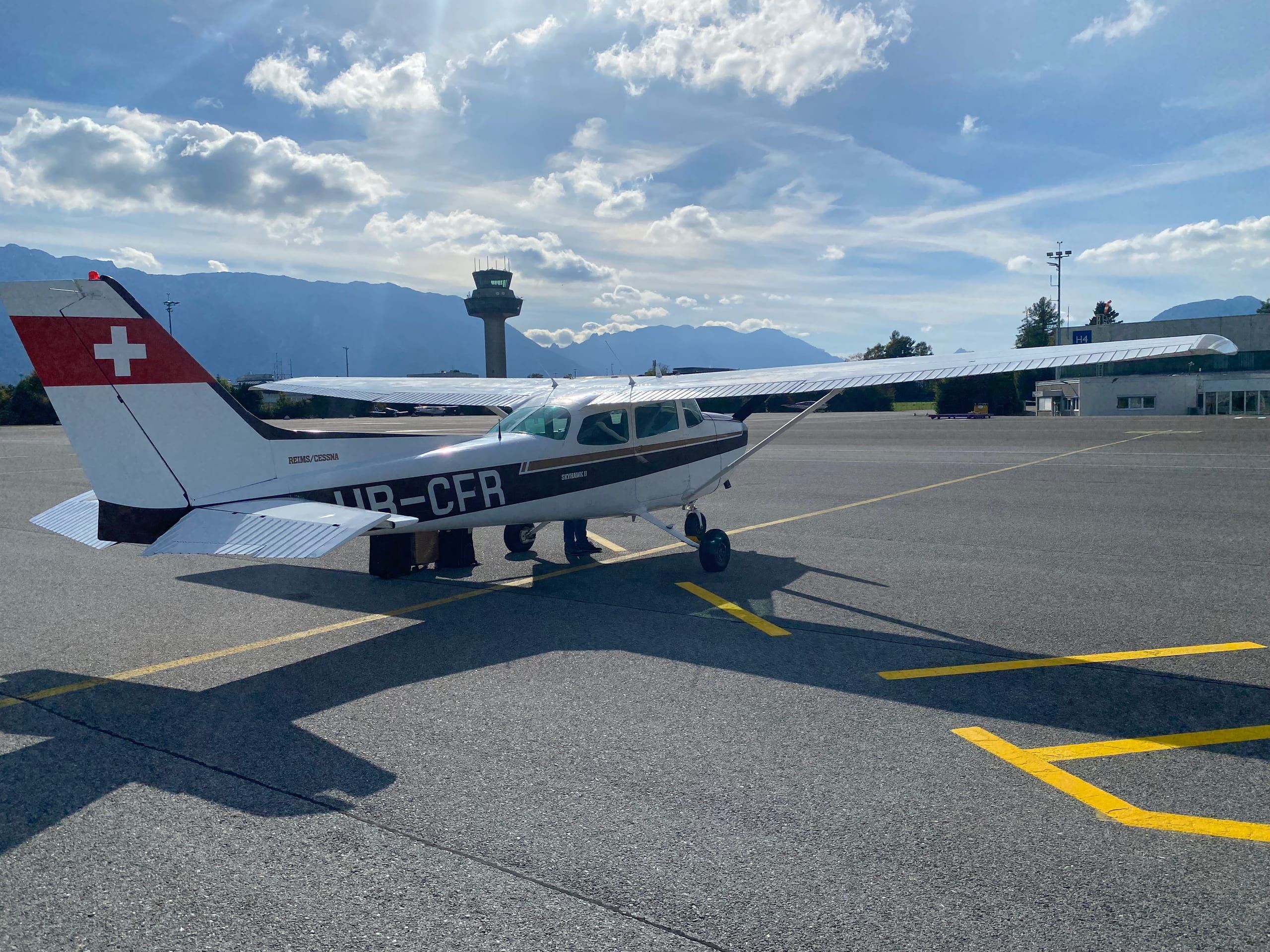 The Cessna HB-CFR on the apron in Salzburg, the tower behind it